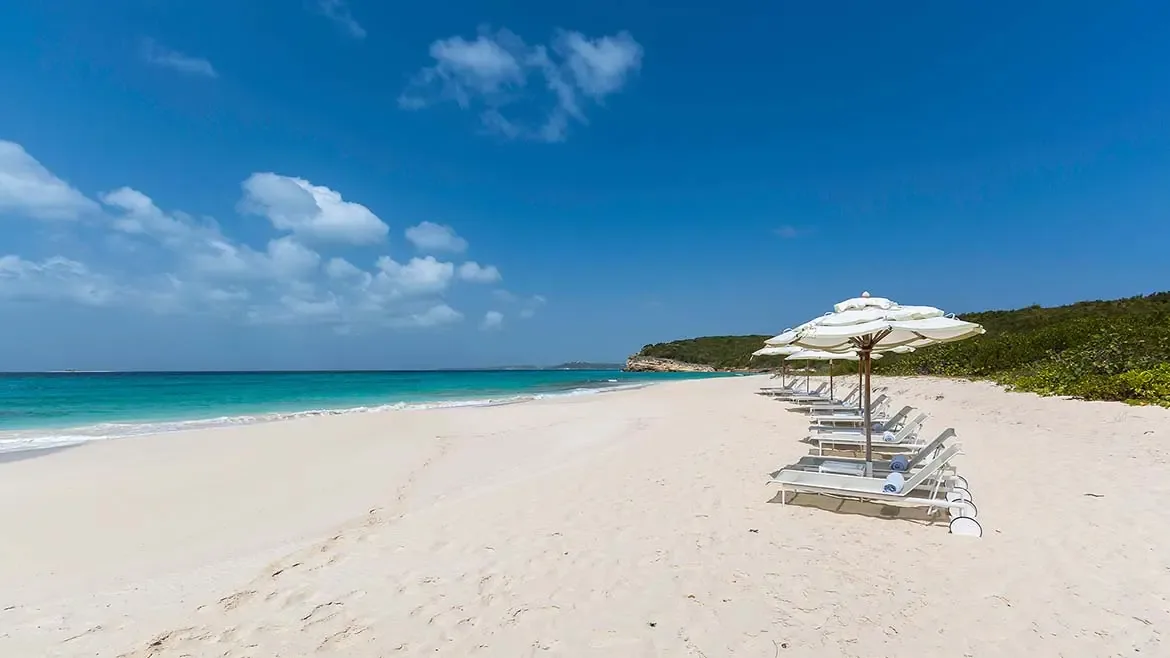 Experience the serenity of Long Bay, Anguilla, where the pristine white sands and breathtaking Caribbean views at Villa Santosha create an unparalleled tropical paradise.