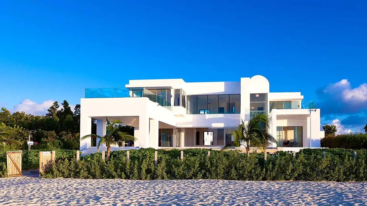 Experience the ultimate Caribbean escape at this breathtaking beachfront villa in Anguilla, featuring sleek modern architecture and expansive glass walls that invite the turquoise ocean views inside. This luxurious white-washed mansion offers a perfect blend of contemporary design and tropical serenity, making it a premier choice for high-end island living.