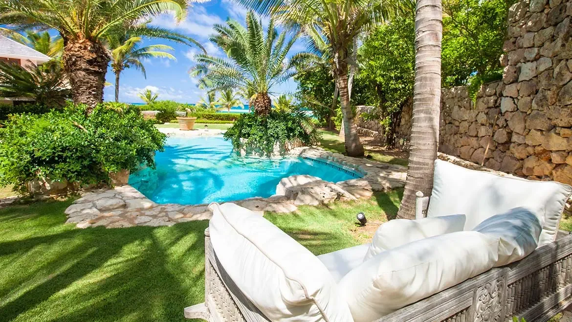 Relax in absolute seclusion at Villa Indigo, where a sparkling private pool is framed by lush tropical gardens and swaying palm trees. This serene outdoor oasis offers the perfect setting for afternoon lounging on plush seating while soaking in the tranquil beauty of your private Caribbean retreat.