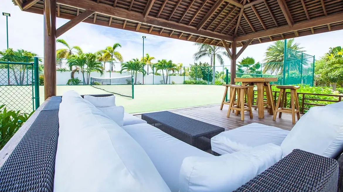 Experience the ultimate in active luxury at Villa Indigo, featuring a private tennis court and an elegant, shaded lounge area perfect for post-match relaxation. This beautifully appointed outdoor space offers a serene tropical setting for guests to enjoy the warm Anguilla sun in total comfort.