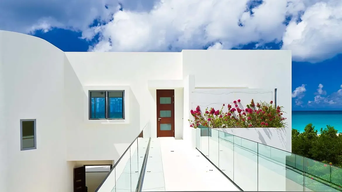 Experience the pinnacle of Caribbean living at this modern Anguilla beach house, featuring sleek minimalist architecture and breathtaking turquoise ocean views. This luxury villa rental offers a sophisticated sanctuary with vibrant tropical landscaping and elegant glass-railed walkways perfect for a premium island getaway.