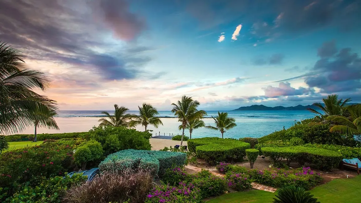 Experience unparalleled Caribbean elegance at Villa Indigo, where lush tropical gardens and manicured hedges frame breathtaking views of the turquoise sea. This luxurious beachfront estate offers the perfect blend of privacy and scenic beauty, making it an ideal choice for an unforgettable Anguilla villa rental.