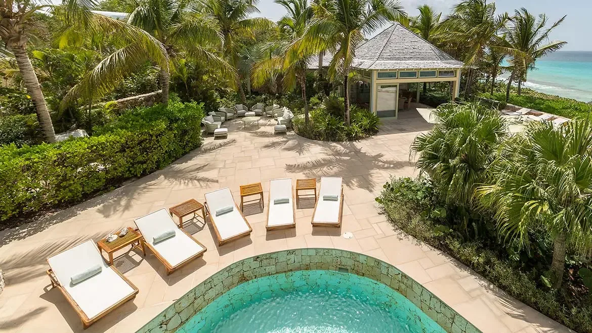 Experience the ultimate in Caribbean relaxation at Villa Santosha's expansive outdoor lounge, perfectly positioned to capture gentle breezes and breathtaking views over Long Bay, Anguilla.