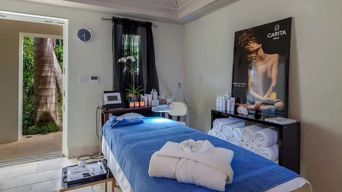 Indulge in ultimate relaxation within the villa's private spa suite, featuring high-end Carita Paris products and professional treatment equipment. The serene space opens to lush tropical views, offering a tranquil sanctuary for personalized massages and wellness rituals during your stay.
