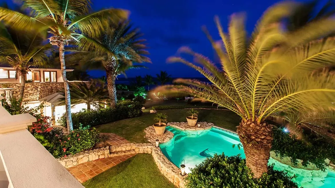 Experience the magical nighttime ambiance of Villa Indigo, a premier Anguilla luxury villa featuring a glowing private pool and lush tropical gardens. This exquisite Caribbean vacation rental offers a serene, illuminated sanctuary perfect for sophisticated evening relaxation and upscale island living.