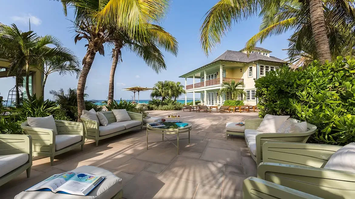 Experience the unparalleled grandeur of Villa Santosha from above, where lush tropical gardens meet the shimmering turquoise waters of Long Bay, Anguilla, offering breathtaking Caribbean views from every corner of the estate.