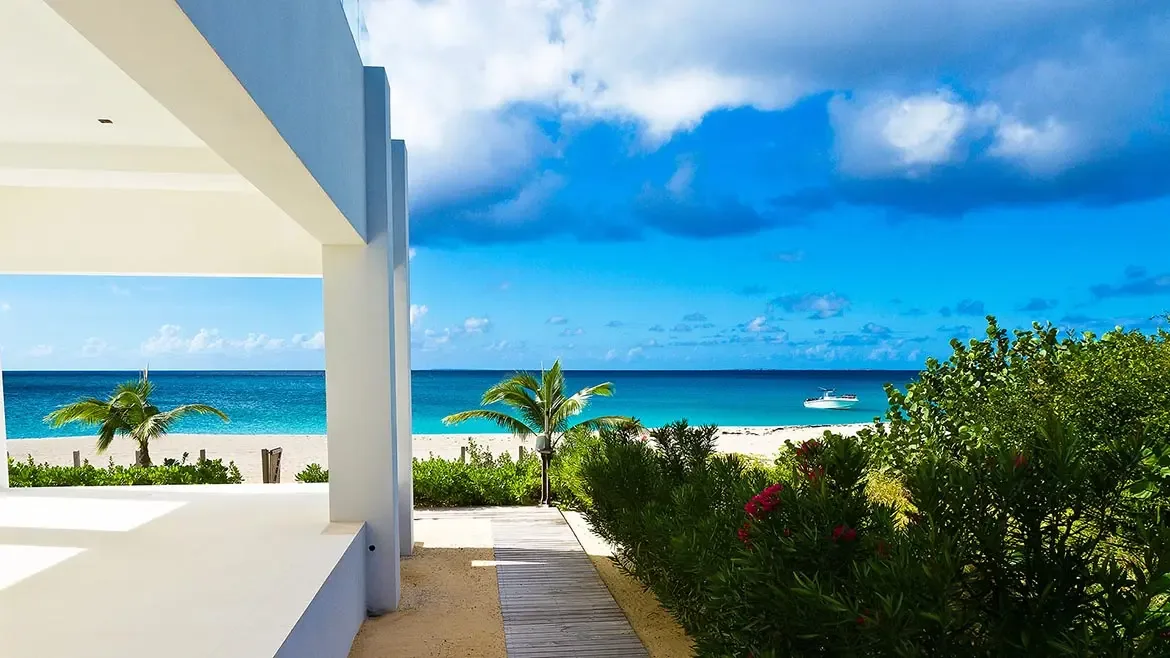 Experience unparalleled luxury at this stunning beachfront villa in Anguilla, where sleek modern architecture meets the pristine turquoise waters of the Caribbean. Relax on the spacious terrace or follow the private wooden path directly onto the soft white sands for the ultimate island getaway.