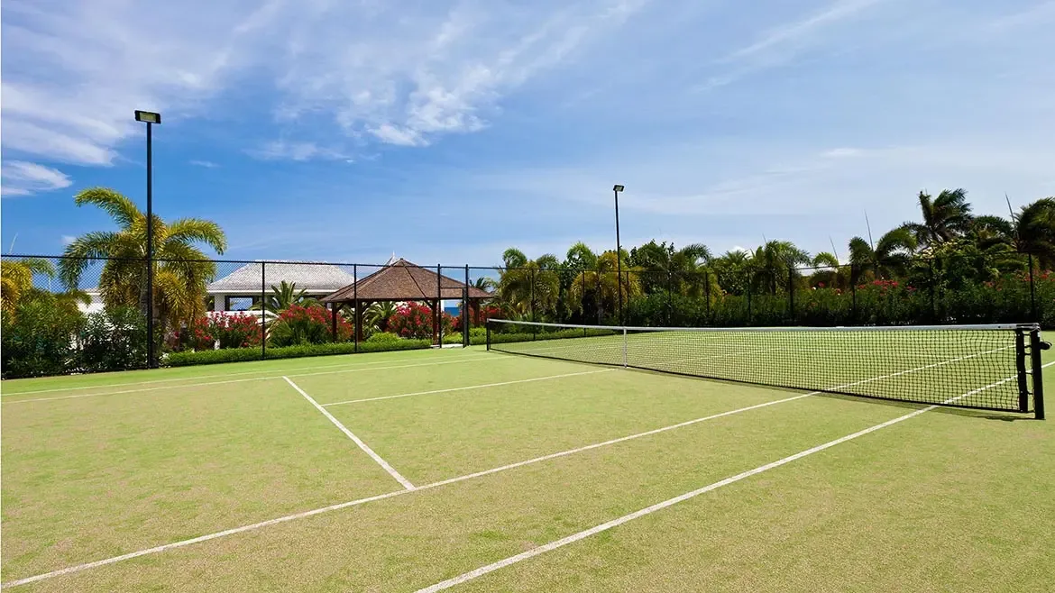 Le Bleu Villa includes a private tennis court surrounded by tropical gardens, adding an active lifestyle dimension to this luxury Anguilla estate. The nearby gazebo and landscaped setting complete the upscale leisure experience.