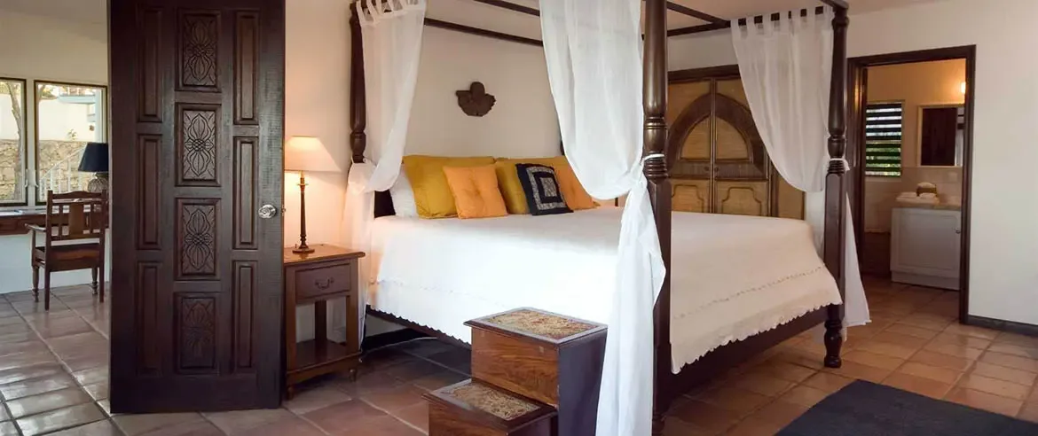 Experience unparalleled tranquility in the master suites of Zenaida Estate, perfectly positioned at Anguilla's highest elevation. Nestled within three acres of lush, manicured gardens, these elegant sanctuaries offer sweeping views of the Caribbean and a refined atmosphere for ultimate relaxation.