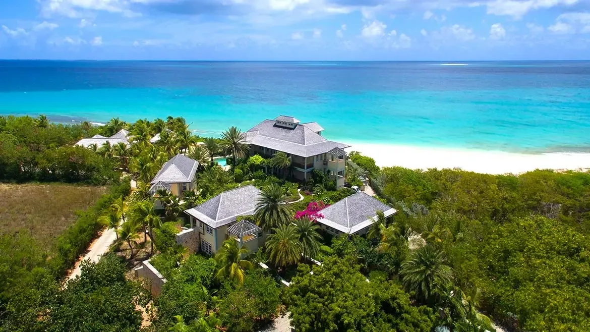 Indulge in a spa-like retreat within Villa Santosha's master bathroom, offering breathtaking panoramas of the Caribbean Sea's turquoise waters at Long Bay.