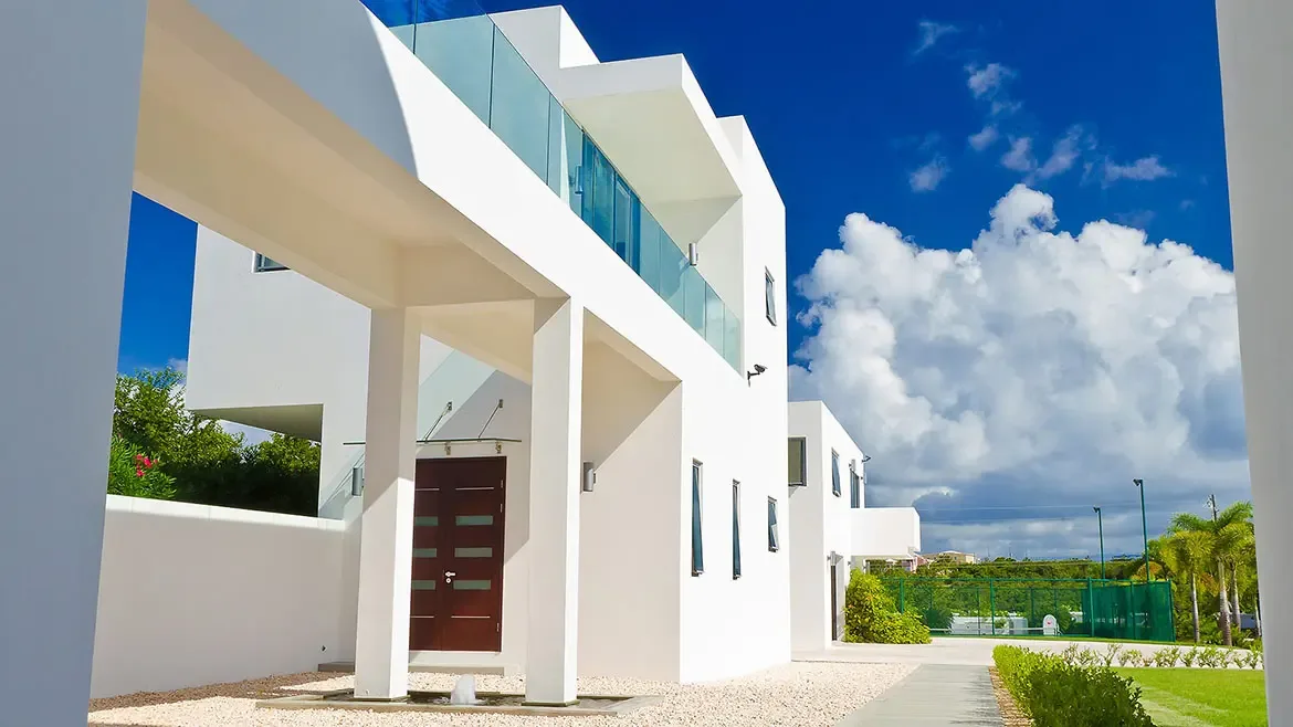 Discover the epitome of Caribbean elegance at this contemporary Anguilla beach house, featuring striking minimalist architecture and sleek glass balconies. This luxury rental property offers a serene tropical sanctuary with modern design elements and bright, open-air spaces perfect for an unforgettable getaway.