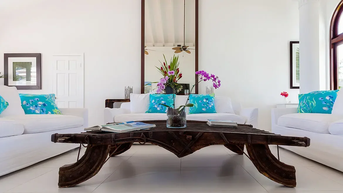 Experience pure Caribbean elegance in the sun-drenched living area of Villa Indigo, featuring plush white seating and vibrant turquoise accents. This luxury Anguilla villa rental offers a sophisticated and airy retreat, perfect for relaxing in style during your tropical getaway.