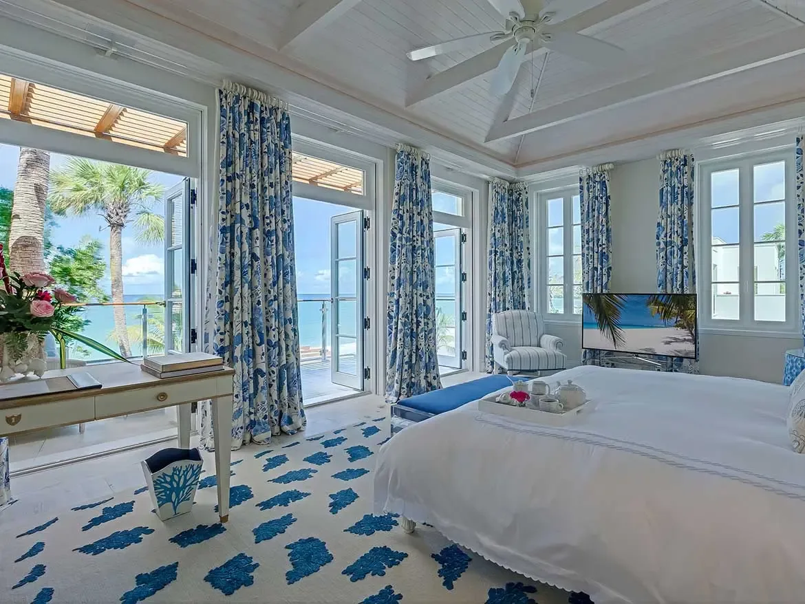 Experience pure tranquility in this beachfront master suite featuring private terrace access and panoramic views of the turquoise Caribbean Sea. The elegantly appointed space blends coastal charm with modern luxury, offering a serene sanctuary at Cerulean Villa in Anguilla.