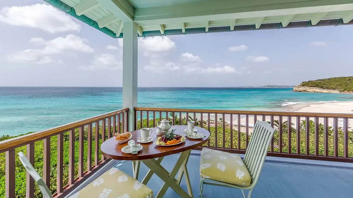 Wake up to breathtaking Caribbean views in the master suite at Villa Santosha, where floor-to-ceiling glass doors open directly to the turquoise waters of Long Bay.