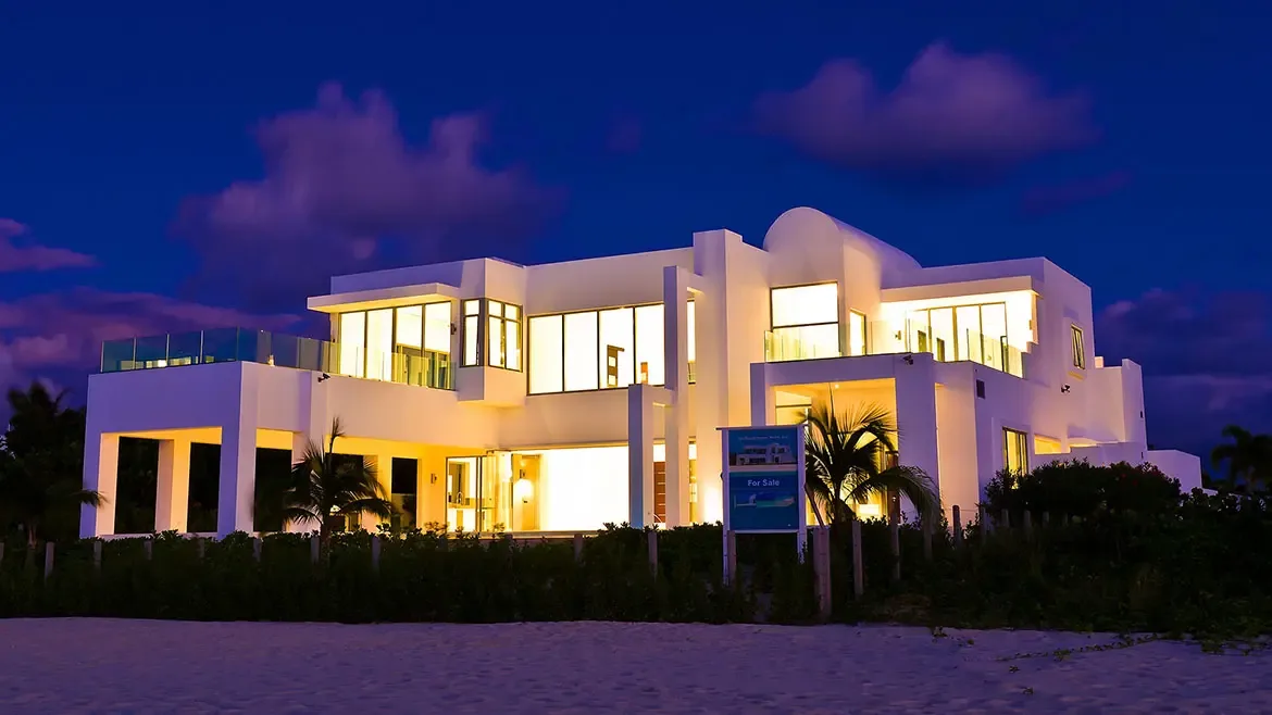 Discover unparalleled Caribbean sophistication at this stunning modern Anguilla villa rental, where contemporary architecture meets pristine beachfront luxury. Bathed in a warm glow at twilight, this expansive estate offers breathtaking views and direct access to the island's world-renowned white sands.