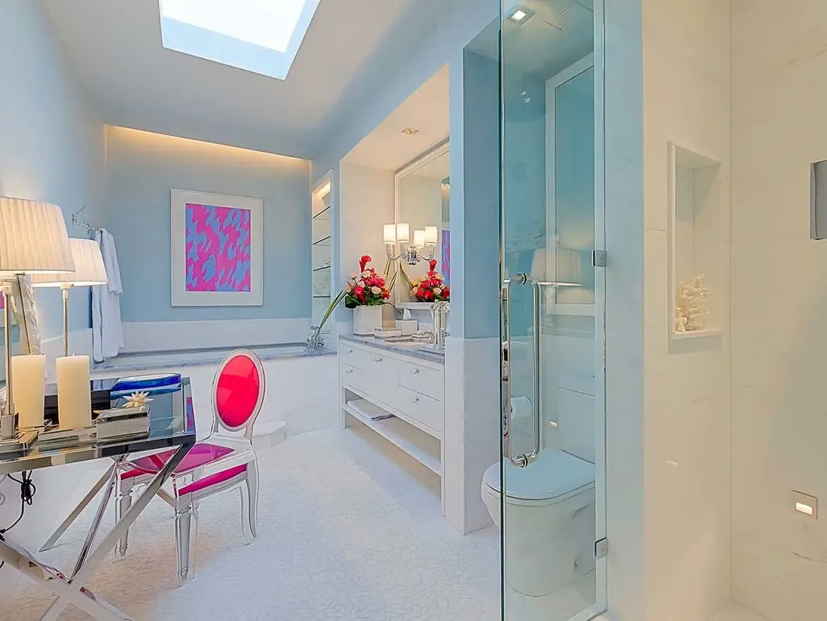 Experience unparalleled luxury in this elegantly appointed ensuite at Cerulean Villa, Anguilla, featuring vibrant designer accents and soft blue tones. This modern bathroom sanctuary offers a serene retreat with high-end finishes, a sleek vanity, and sophisticated glass features.