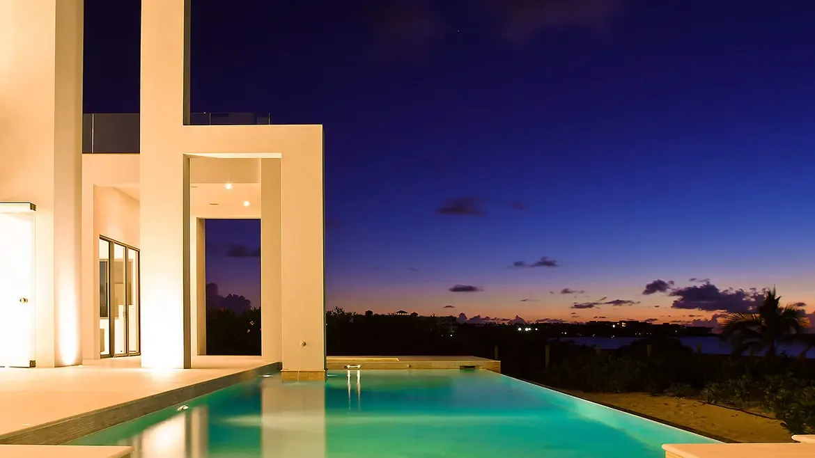 Experience unparalleled Caribbean luxury at this modern Anguilla beach house featuring a stunning infinity pool and sleek geometric architecture. Relax under vibrant twilight skies and enjoy world-class ocean views from your private contemporary sanctuary.