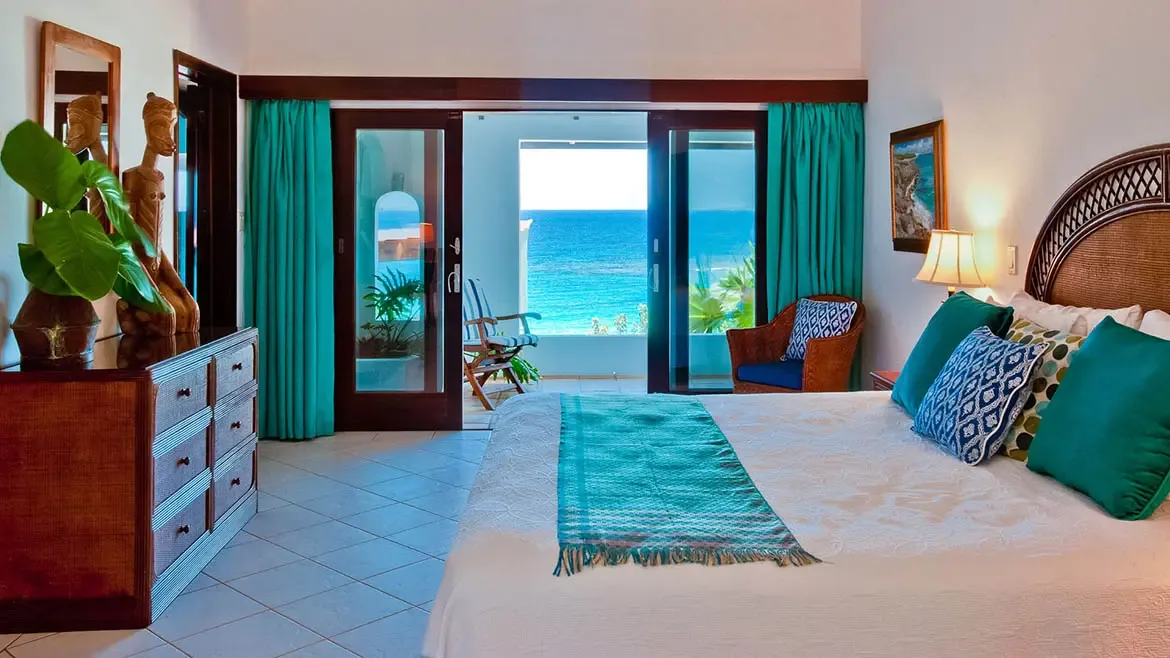 The interior living spaces at Zenaida Estate blend Caribbean charm with refined European elegance, featuring locally sourced stone walls, coral stone floors, and bespoke Italian furnishings.