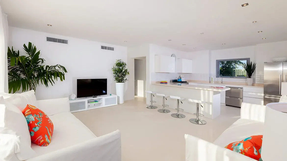 This bright and airy open-plan living area at a luxury Anguilla beach house offers a sophisticated modern design perfect for a Caribbean getaway. Featuring a sleek chef's kitchen and a spacious lounge, this villa provides the ultimate setting for a relaxing and high-end island vacation.