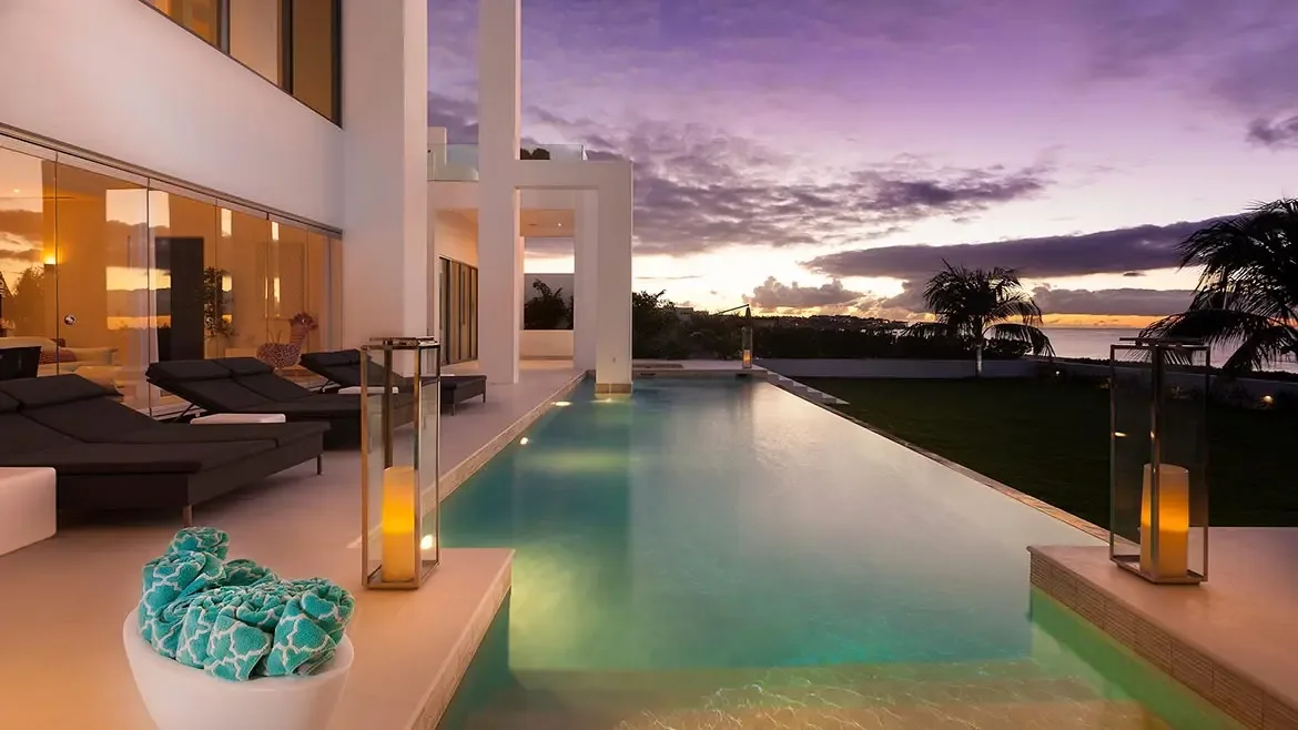 Experience the pinnacle of Caribbean luxury at this ultra-modern Anguilla villa, featuring a stunning infinity pool that seamlessly blends into the horizon. Relax on the elegant sun-drenched terrace while enjoying breathtaking sunset views over the turquoise ocean waters.