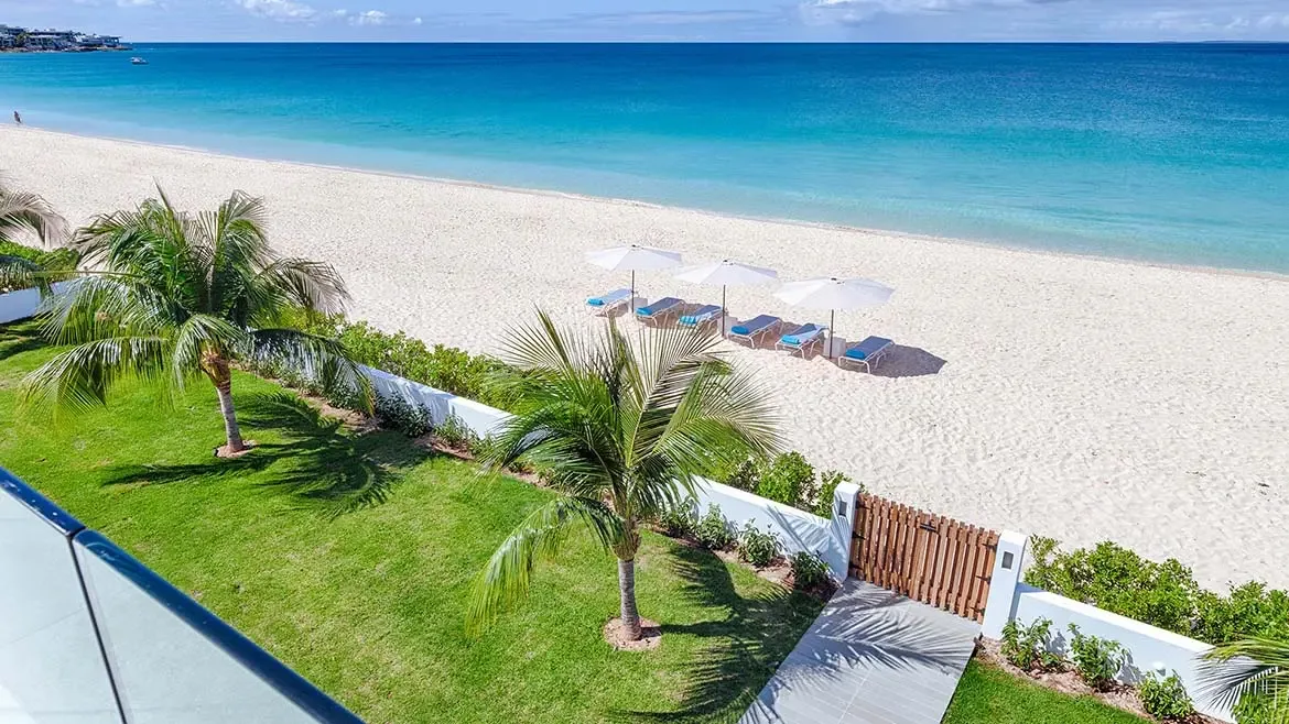 Experience the epitome of Caribbean luxury at this Anguilla beach house, featuring private gate access to a pristine white sand beach. Relax in style with premium lounge chairs and umbrellas overlooking the vibrant turquoise waters of the Caribbean Sea.
