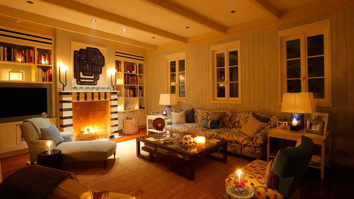 Experience ultimate relaxation in the beautifully appointed living room at Villa Cerulean, featuring a cozy fireplace and sophisticated interior design perfect for evening unwinding. This warm and inviting space offers the ideal blend of comfort and high-end elegance for your luxury Anguilla villa vacation.