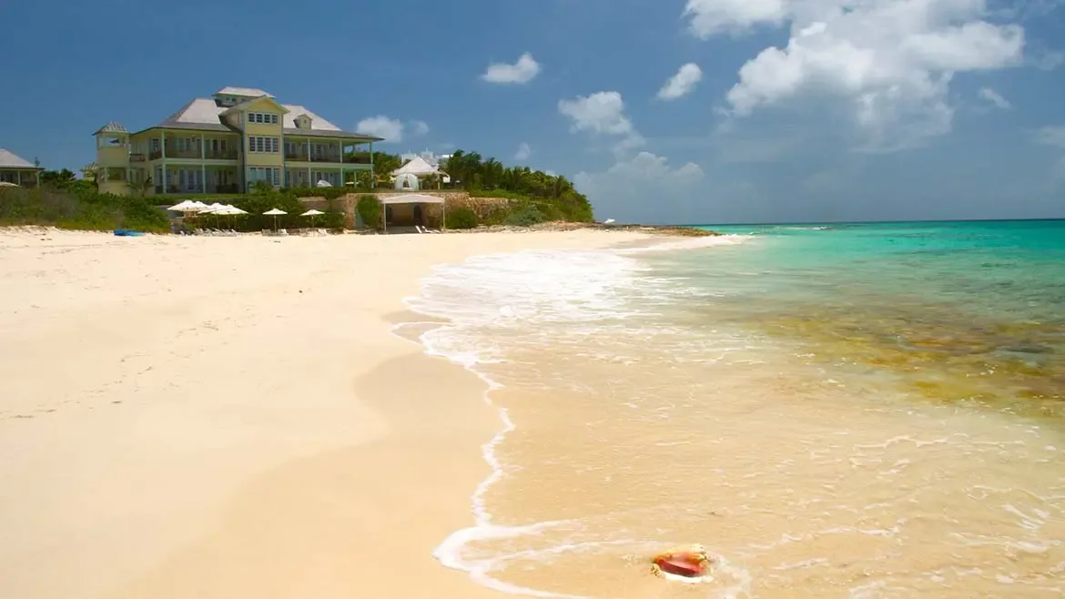 Discover a private tropical sanctuary at Villa Santosha, where secluded guest cottages are nestled amidst the lush, sun-drenched landscapes of Long Bay, Anguilla.