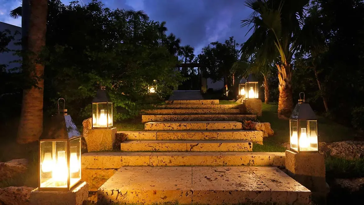 Follow the warm glow of elegant lanterns up the stone staircase of Cerulean Villa, an exquisite luxury rental in Anguilla. These beautifully landscaped tropical gardens create a magical atmosphere for unforgettable island evenings under the stars.