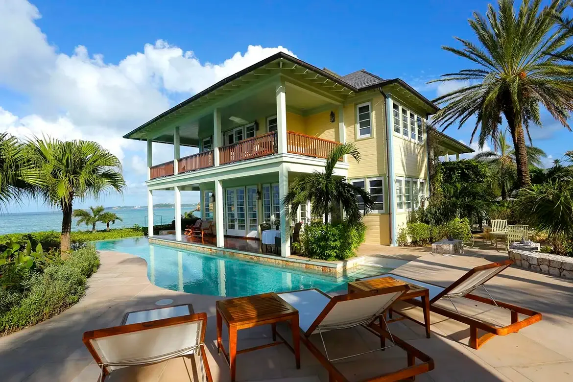 Meander through the enchanting tropical gardens of Villa Santosha, where vibrant bougainvillea and swaying palms line the path to your private paradise.