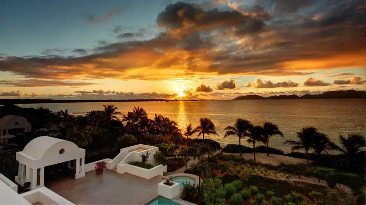 Stunning sunset view over the ocean and palm trees from the terrace of Villa Arushi.