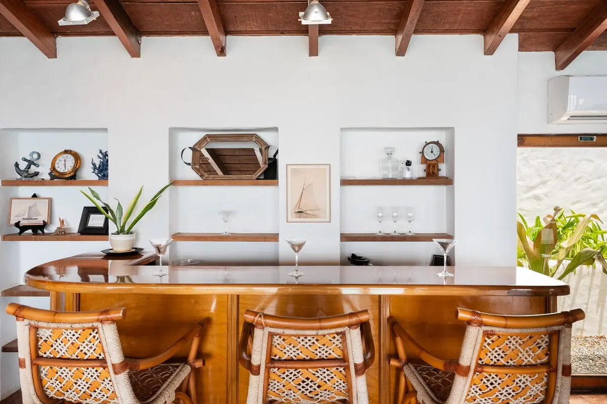 Bar counter with decorative shelving and stools.