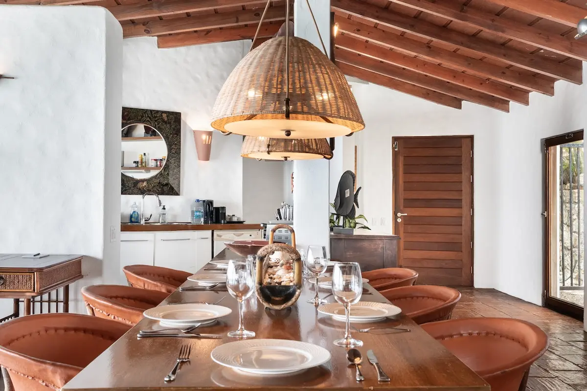 Dining area set beneath woven pendant lights.