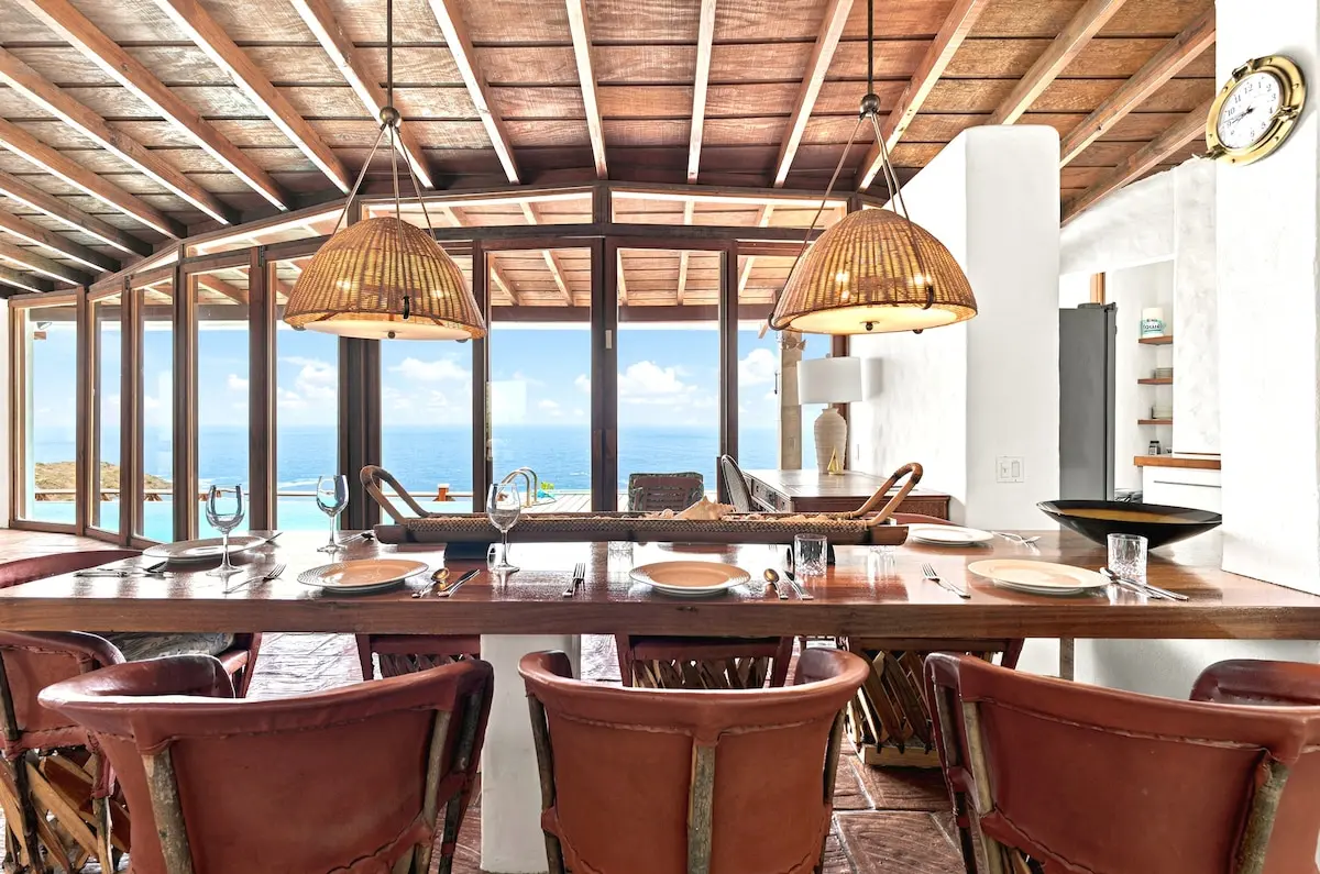 Dining table positioned to enjoy panoramic ocean views.