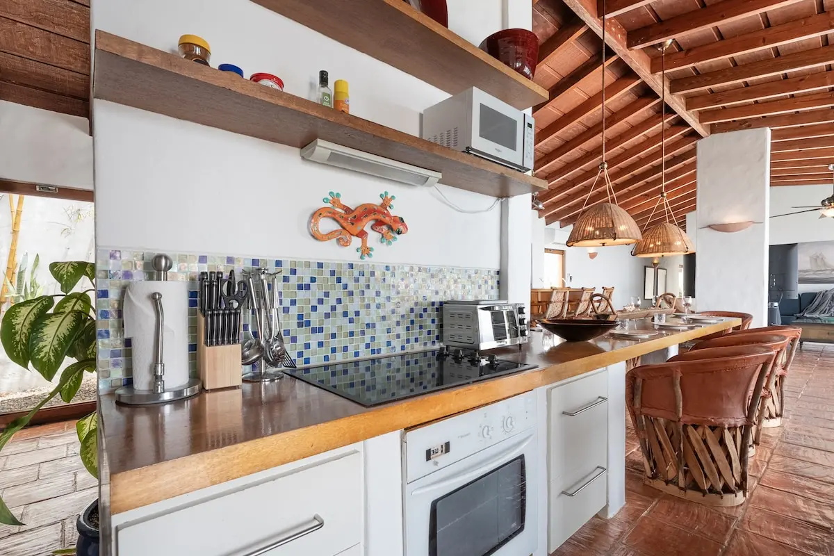 Kitchen appliances and colorful tile backsplash.