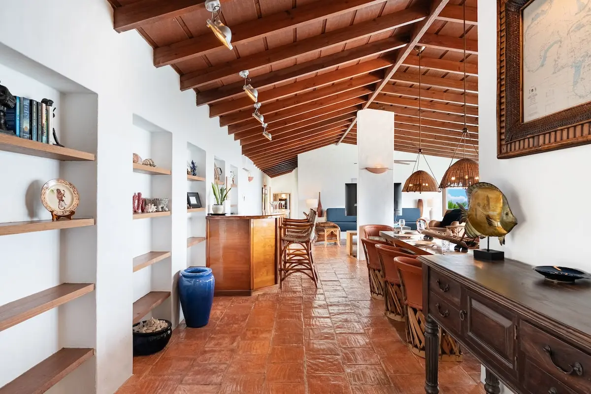 Kitchen island and wood cabinetry beneath the vaulted ceiling.
