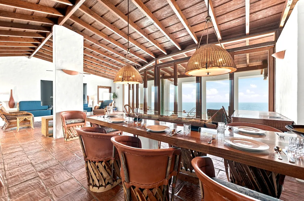 Open-plan living and dining space facing the ocean.