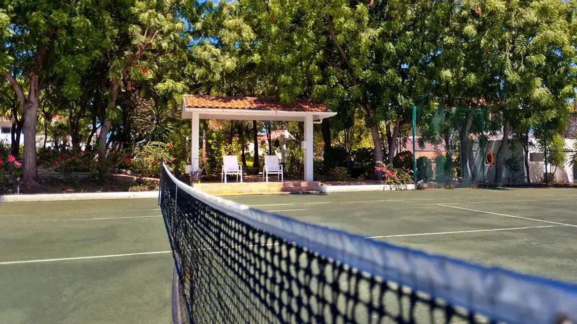 Landscaped grounds and tennis courts at the Nettle Bay residence.