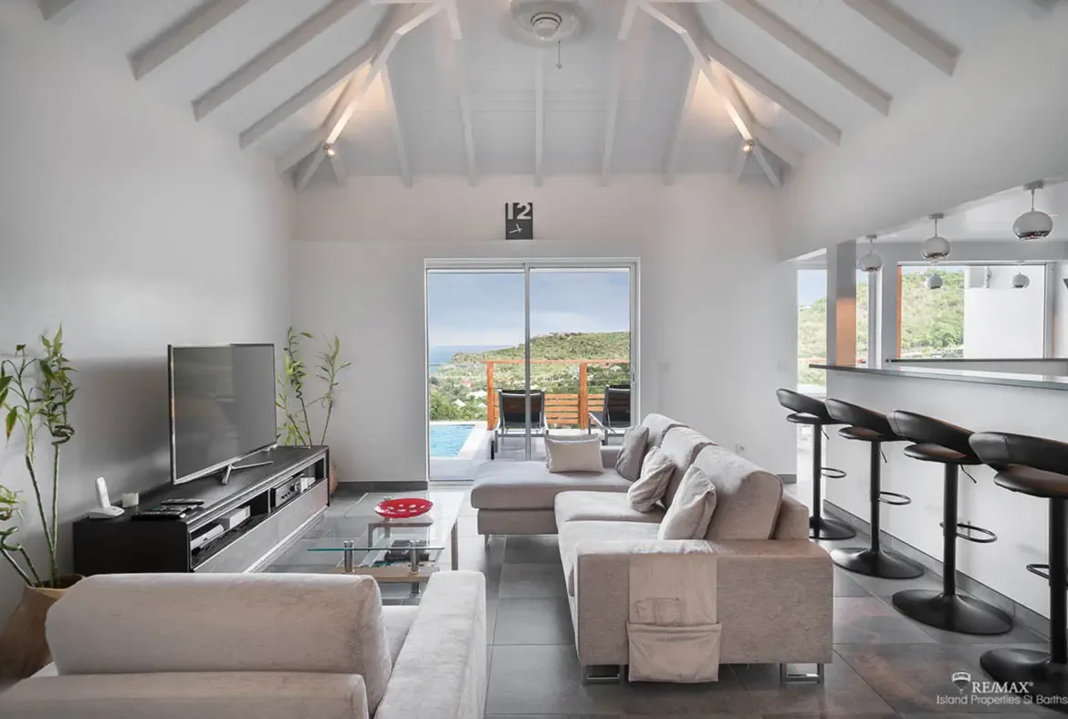 An open-concept living area with vaulted ceilings flows to the terrace — your indoor-outdoor lifestyle with ocean views.