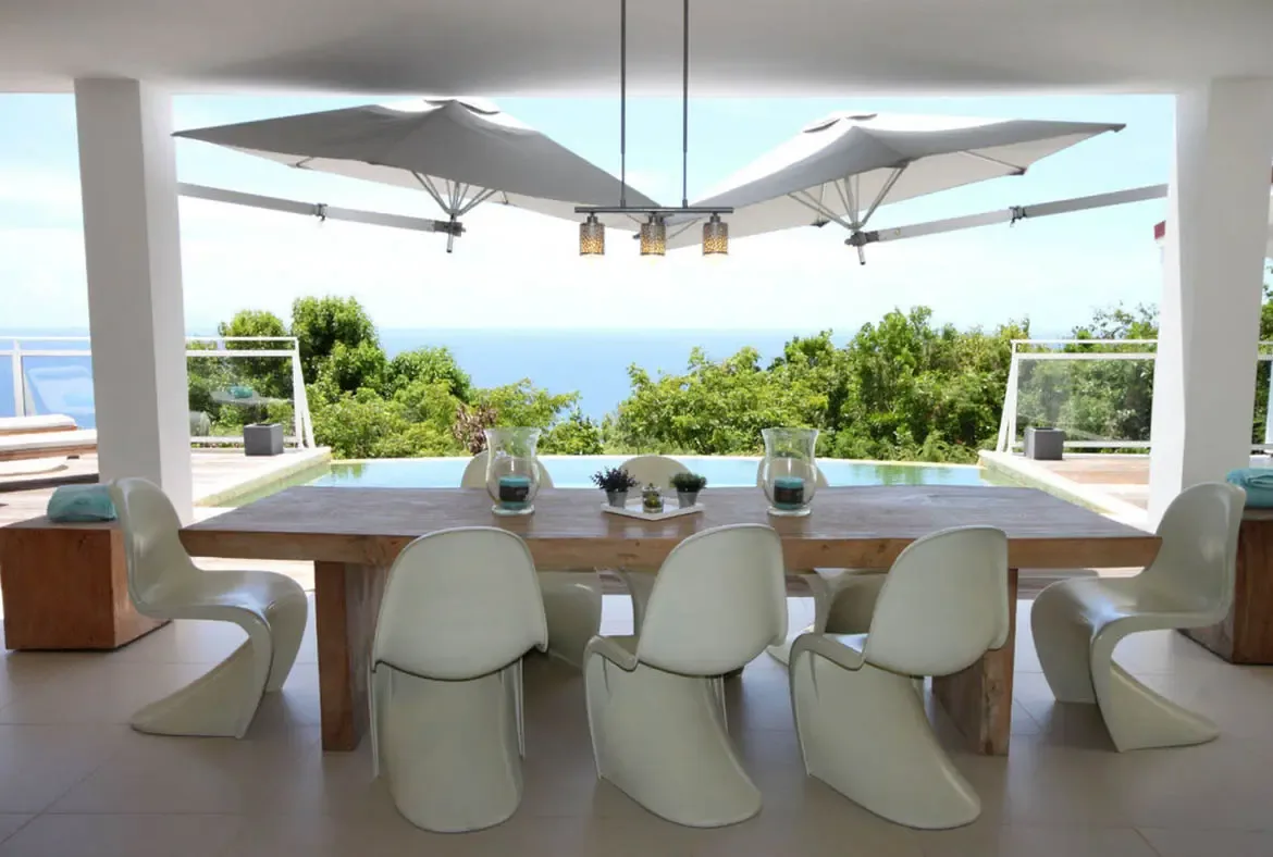 Dine under the stars or enjoy a long lunch at the elegant outdoor table overlooking the turquoise pool.