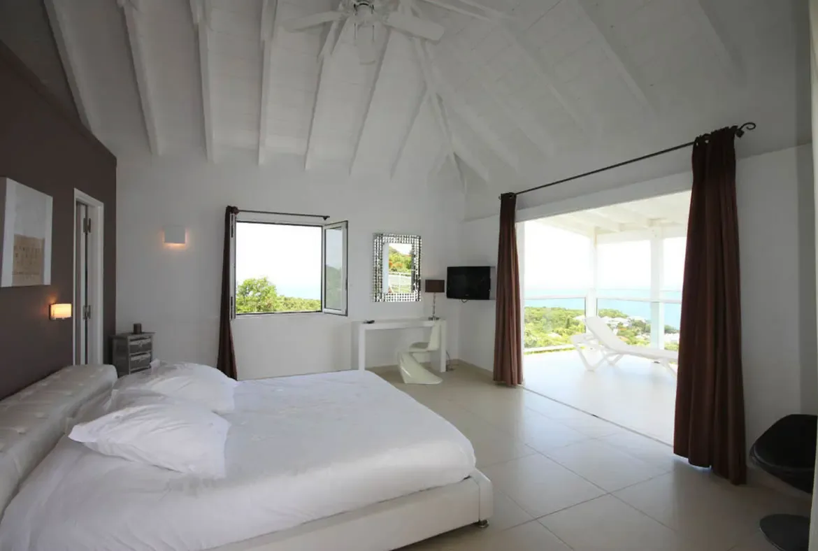 Wake up to breathtaking tropical vistas with floor-to-ceiling glass doors that lead directly from the bedroom to the private terrace.