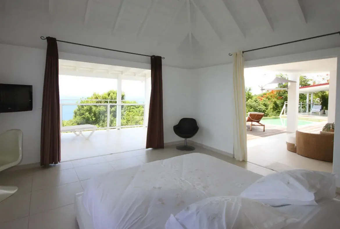 Wake up to gentle sea breezes and panoramic views in this elegantly minimalist bedroom that opens directly onto the terrace.