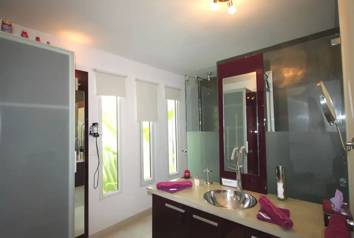 Sleek fixtures and bold accents define the sophisticated contemporary bathrooms throughout the villa.