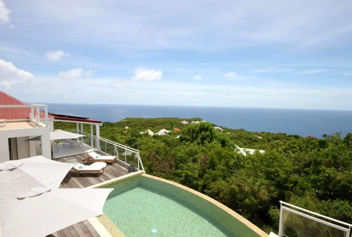 Experience the pinnacle of Caribbean luxury from Villa Dasha's infinity pool, where turquoise waters blend seamlessly with the horizon over Lurin.