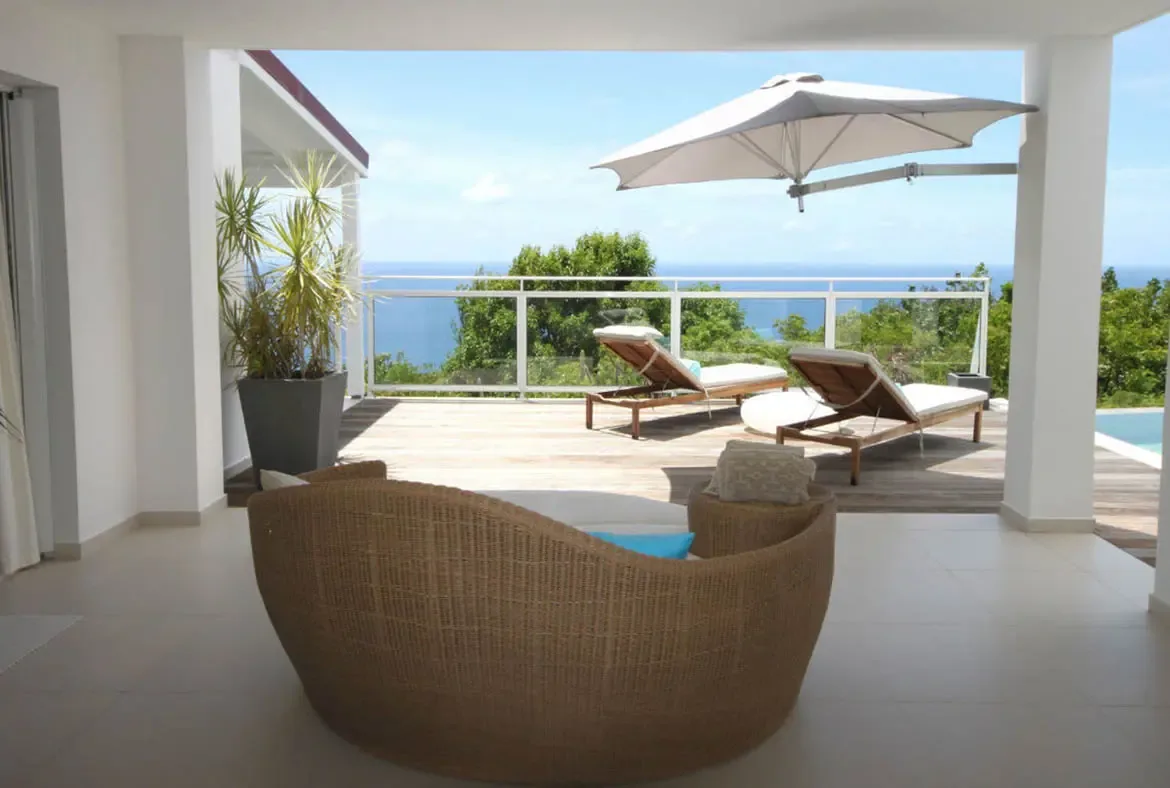 Bask in the St. Barths sun on the expansive wooden deck, designed for ultimate relaxation with panoramic views of the Caribbean Sea.