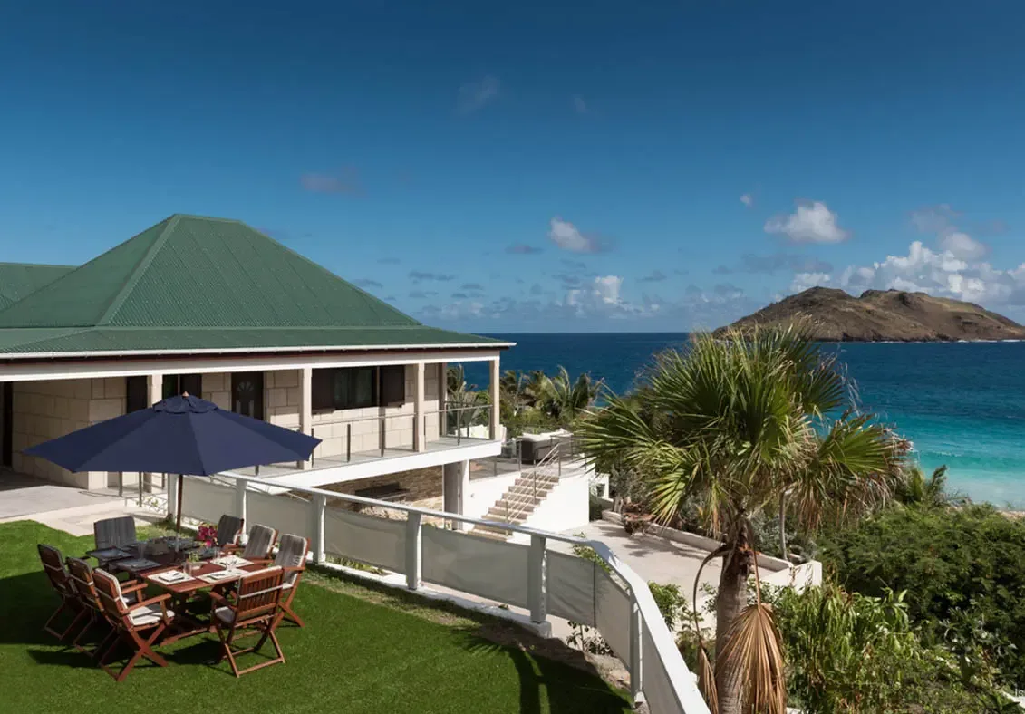 An elevated perspective of Villa Gem-Palm Springs, where manicured lawns meet the endless blue of the Atlantic.