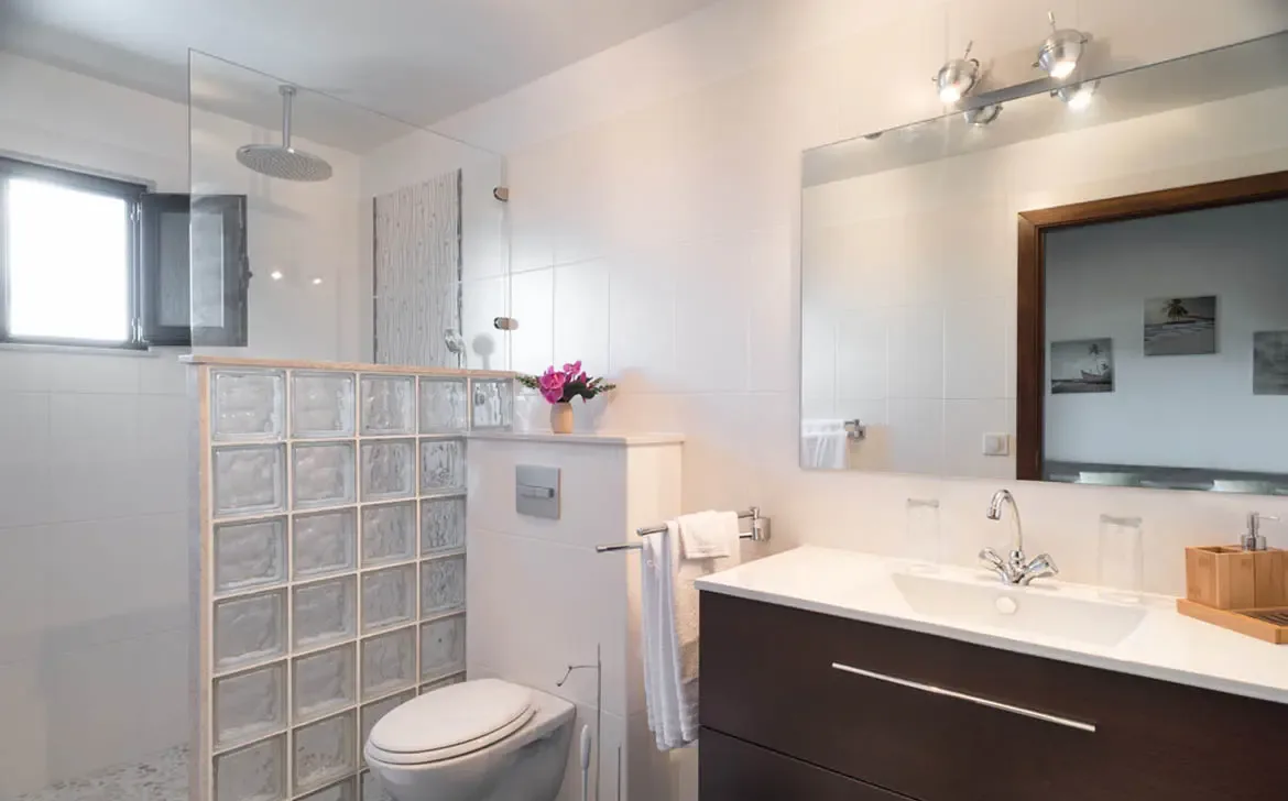 The master ensuite is a haven of modern minimalism, featuring a walk-in rainfall shower and elegant fixtures for a spa-like experience.