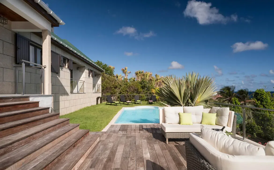 Enjoy seamless indoor-outdoor living on the private pool deck, perfect for sunbathing or relaxing in the shade after a refreshing dip.