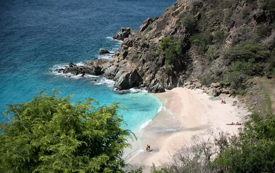 Framed by tropical greenery, Shell Beach reveals itself as a pristine crescent of pale sand cradled by rocky cliffs. Crystalline turquoise waters meet gentle surf—your private sanctuary where nature is the only host.