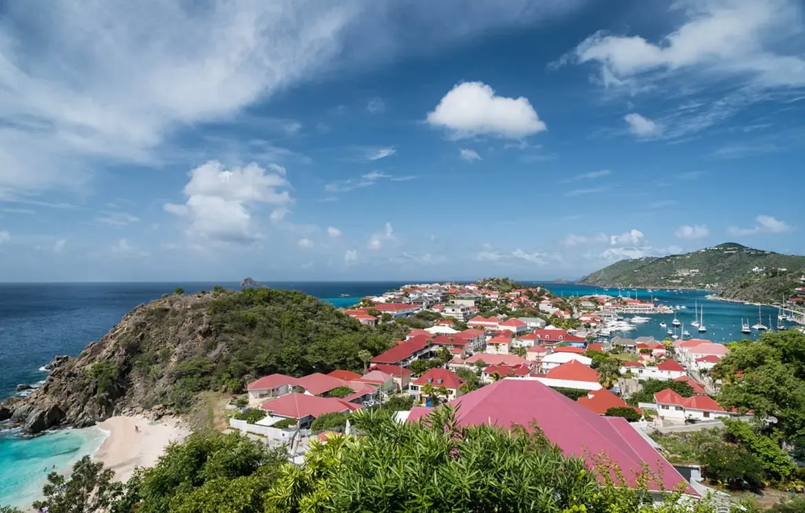 From your private hillside perch, Gustavia unfolds in all its glory—red rooftops cascading to a harbor dotted with yachts, the crystalline Caribbean meeting Shell Beach's white sands. This is the Caribbean's most coveted view, yours from dawn to dazzling sunset.