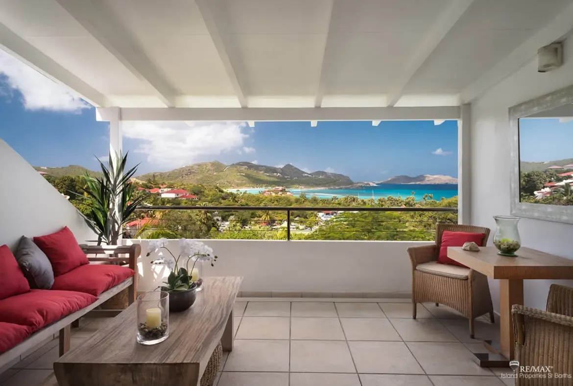 A spacious balcony with ocean and mountain views — your perfect spot for morning coffee in St. Barths.